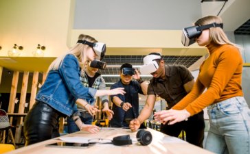 Virtual Reality and Team-Building- a group of people using VR headsets in a room