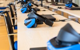 Close up of many VR headsets in a classroom