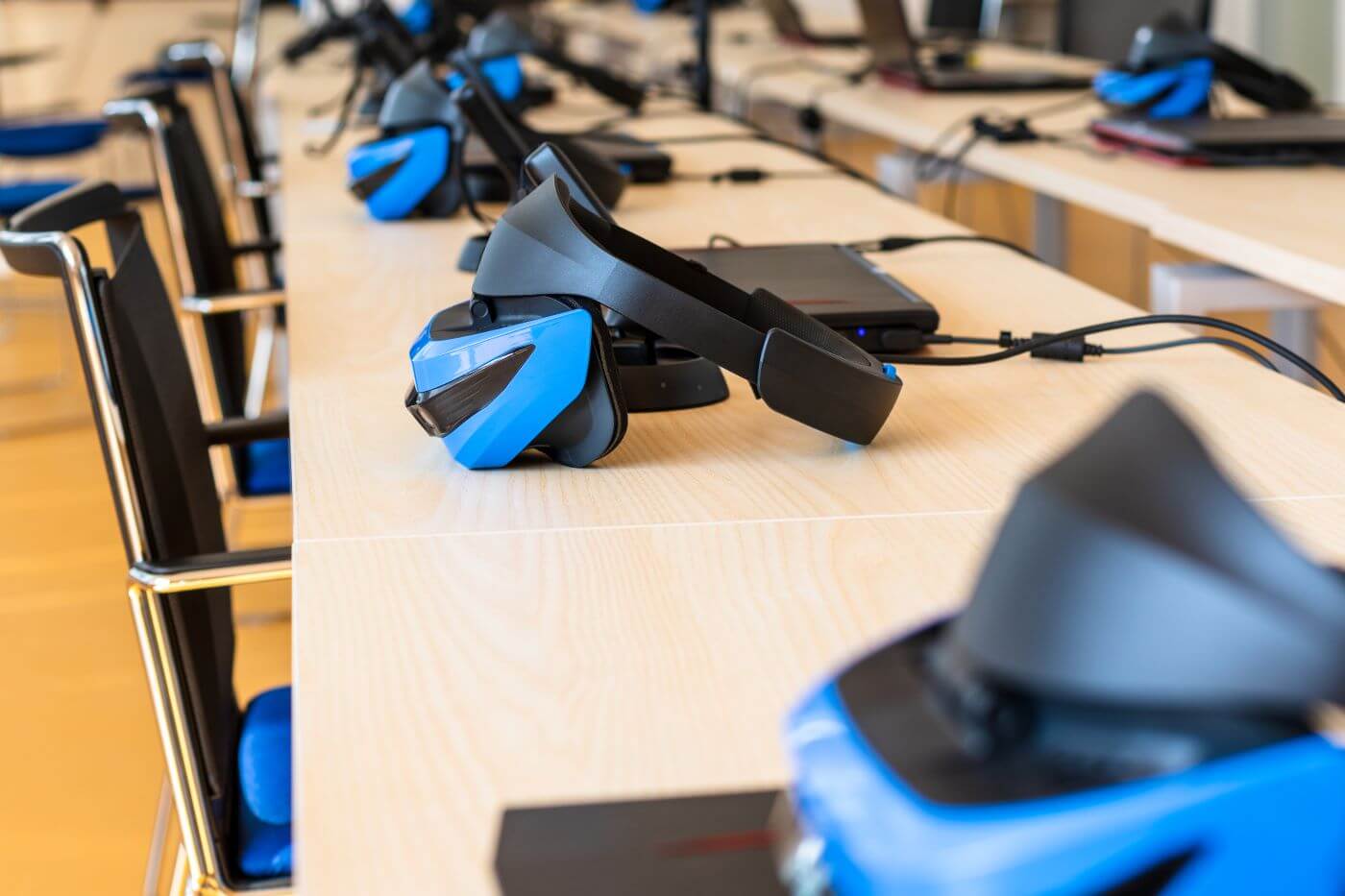 Close up of many VR headsets in a classroom